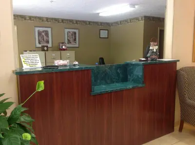 a bar in a waiting room with a counter at Brookshire Inn in Inez