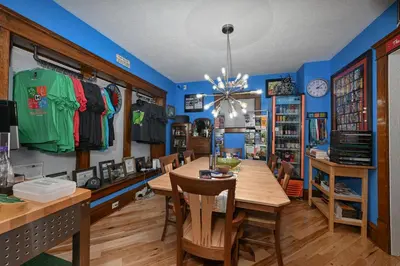 a dining room with a long table in a room with blue walls at Berrodin Bed & Breakfast in Akron