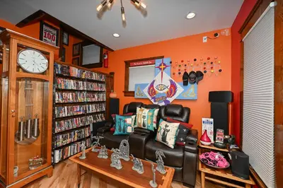 a living room with a couch and a book shelf at Berrodin Bed & Breakfast in Akron