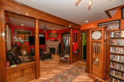 a living room with red walls and a grandfather clock at Berrodin Bed & Breakfast in Akron