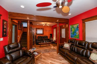 a living room with leather furniture and red walls at Berrodin Bed & Breakfast in Akron
