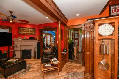a living room with a clock and a fireplace at Berrodin Bed & Breakfast in Akron