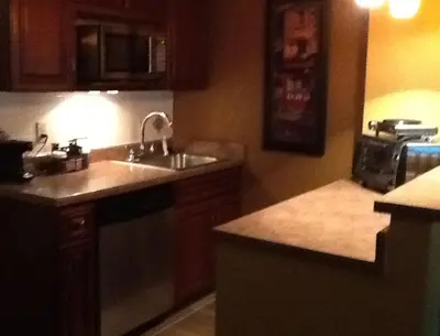 a kitchen with a sink and a counter top at Ramada by Wyndham Catlettsburg Ashland in Catlettsburg