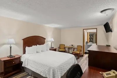 a hotel room with a bed and a desk at Knights Inn Ashland in Ashland