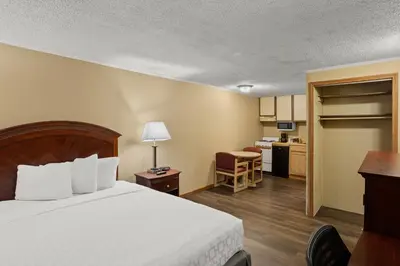 a hotel room with a bed and a kitchen at Knights Inn Ashland in Ashland