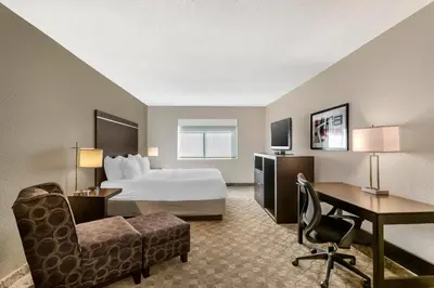 a hotel room with a bed and a desk at Comfort Inn Huntington near University area in Huntington