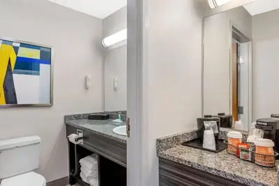 a bathroom with a sink and a mirror at Comfort Inn Huntington near University area in Huntington