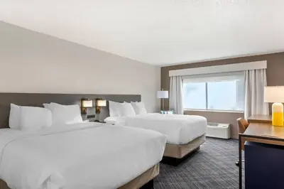 a hotel room with two beds and a window at Comfort Inn Huntington near University area in Huntington