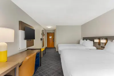a hotel room with two beds and a tv at Comfort Inn Huntington near University area in Huntington
