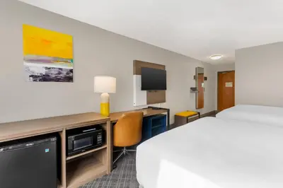 a hotel room with a bed and a desk at Comfort Inn Huntington near University area in Huntington