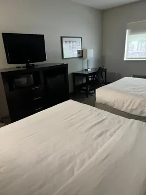 a hotel room with two beds and a flat screen tv at Comfort Inn Huntington near University area in Huntington