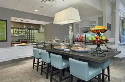 a large kitchen with a table with fruit on it at Hilton Garden Inn Columbus-University Area in Columbus