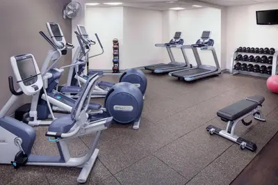 a gym with several rows of tread machines at Wyndham Independence in Independence