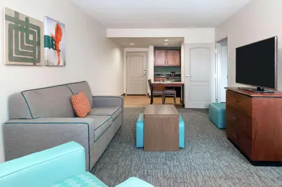 a living room with a couch and a flat screen tv at Homewood Suites by Hilton Cleveland-Beachwood in Beachwood