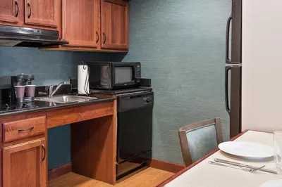 a small kitchen with a sink and a microwave at Homewood Suites by Hilton Cleveland-Beachwood in Beachwood