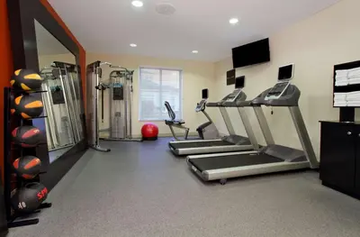 a gym with several treadmills and cardio machines at Hilton Garden Inn Columbus Airport in Columbus