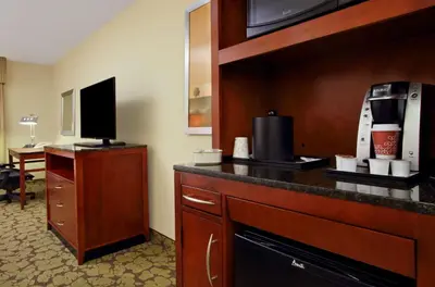 a hotel room with a counter with a coffee maker at Hilton Garden Inn Columbus Airport in Columbus
