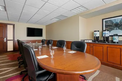 a conference room with a large wooden table and chairs at Hilton Garden Inn Cleveland Downtown in Cleveland
