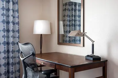 a desk with a lamp and a chair in a room at Hilton Garden Inn Cleveland Downtown in Cleveland