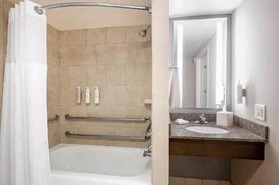 a bathroom with a tub and a sink at Hilton Garden Inn Cleveland Downtown in Cleveland