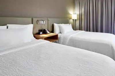 a hotel room with two beds and a telephone at Hilton Garden Inn Columbus/Polaris in Columbus