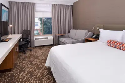 a hotel room with a bed and a desk and a chair at Hilton Garden Inn Columbus/Polaris in Columbus