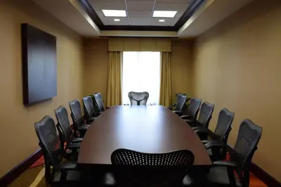 a conference room with a large table and chairs at Hilton Garden Inn Columbus/Polaris in Columbus