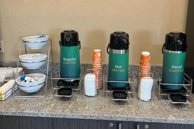 a counter with a group of cups and bowls at Quality Inn Huntington University Area in Huntington