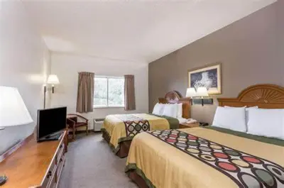 a hotel room with two beds and a television at Quality Inn Huntington University Area in Huntington