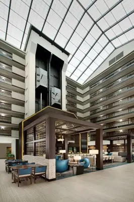 a large building with tables and chairs and a glass ceiling at Embassy Suites by Hilton Columbus in Columbus