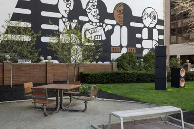 a table and benches in front of a building at Hampton Inn Cleveland-Downtown in Cleveland
