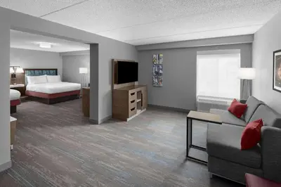 a hotel room with a couch and a bed at Hampton Inn Cleveland-Downtown in Cleveland