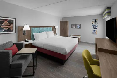 a hotel room with a bed and a couch at Hampton Inn Cleveland-Downtown in Cleveland