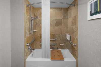 a bathroom with a bath tub with a sink at Hampton Inn Cleveland-Downtown in Cleveland