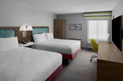 a hotel room with two beds and a television at Hampton Inn Cleveland-Downtown in Cleveland