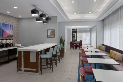 a restaurant with tables and chairs and a bar at Hampton Inn Cleveland-Downtown in Cleveland