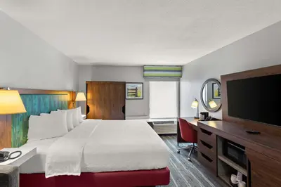 a hotel room with a bed and a flat screen tv at Hampton Inn Bridgeport/Clarksburg in Bridgeport