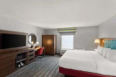 a hotel room with a bed and a flat screen tv at Hampton Inn Bridgeport/Clarksburg in Bridgeport
