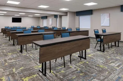 a classroom with desks and chairs in a room at Hampton Inn Cleveland-Airport/Tiedeman Road in Brooklyn