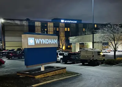 a sign in a parking lot in front of a building at Wyndham Columbus in Worthington