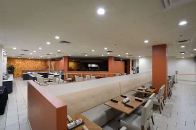 a restaurant with tables and chairs and a bar at Wyndham Columbus in Worthington
