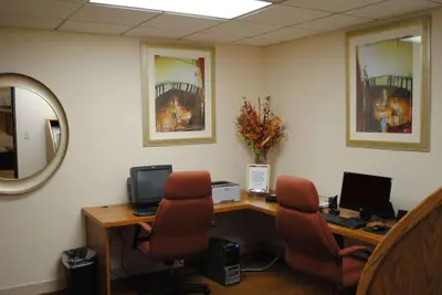 an office with a desk with two computers and two chairs at Wyndham Columbus in Worthington