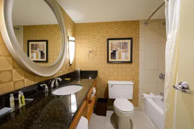 a bathroom with a sink and a toilet and a mirror at Wyndham Columbus in Worthington