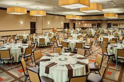 a banquet hall with white tables and chairs at Wyndham Columbus in Worthington