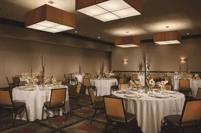a banquet hall with white tables and chairs at Wyndham Columbus in Worthington
