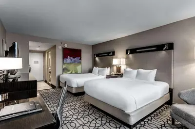 a hotel room with two beds and a couch at Hilton Columbus at Easton in Columbus