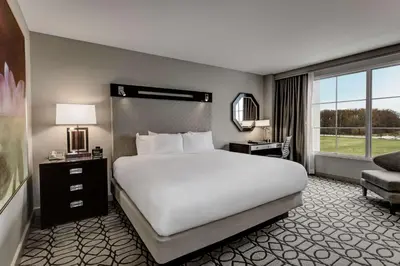 a bedroom with a large white bed and a window at Hilton Columbus at Easton in Columbus
