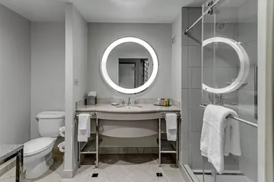 a bathroom with a sink and a toilet and a mirror at Hilton Columbus at Easton in Columbus
