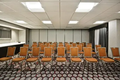 a room with rows of orange chairs in it at Hampton Inn & Suites Columbus-Easton Area in Columbus