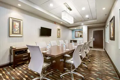 a conference room with a long table and chairs at Hampton Inn West in Columbus